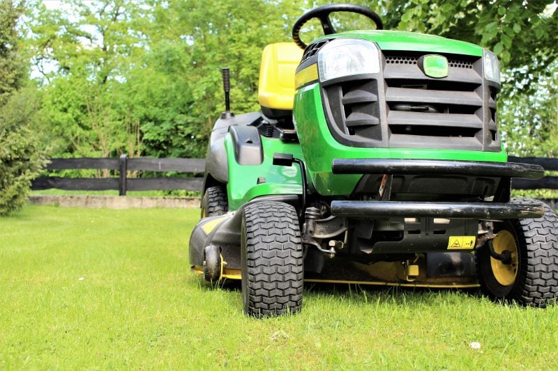 A lawn mower to be stored in a prefab garage